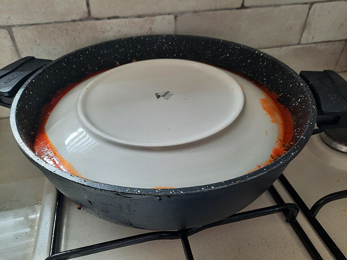 הנחת צלחת הפוכה על כרוב ממולא בזמן הבישול
